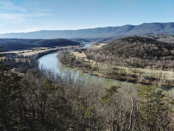 Scenic view of river amidst mountains against sky