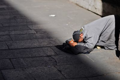 High angle view of man lying on floor