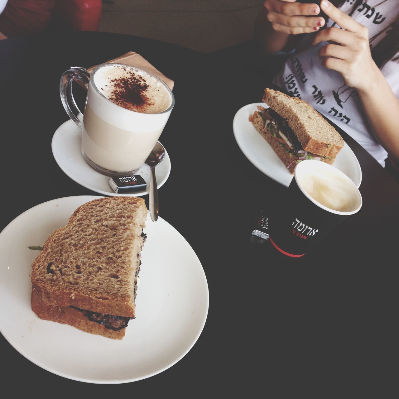 food and drink, food, freshness, indoors, person, ready-to-eat, sweet food, indulgence, unhealthy eating, table, dessert, holding, plate, still life, high angle view, drink, bread, part of