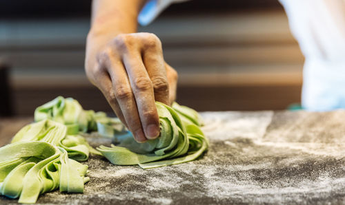 Midsection of person preparing food in kitchen