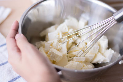 Cropped hand of woman preparing food