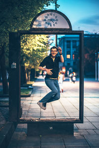 Portrait of young man on footpath