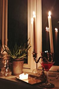 Close-up of tea light candles on table at home