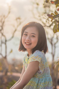 Portrait of a smiling young woman standing outdoors