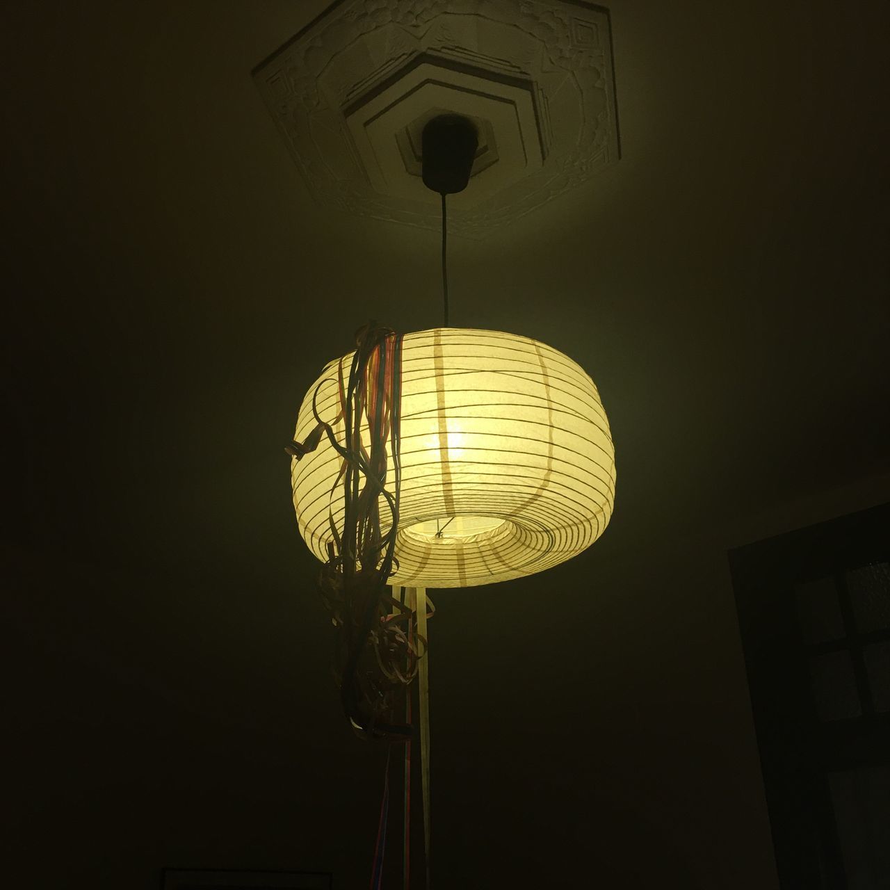 LOW ANGLE VIEW OF ILLUMINATED PENDANT LIGHT