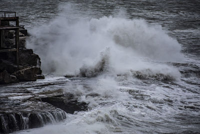 Waves breaking on rocks in sea