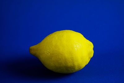 Close-up of lemon slice against blue background