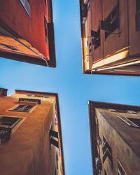 Directly above shot of buildings against blue sky