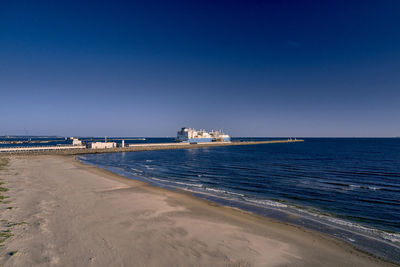 Scenic view of sea against clear blue sky