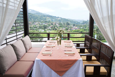 Empty chairs and tables in balcony