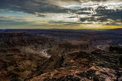 Scenic view of rocky mountains against sky during sunset