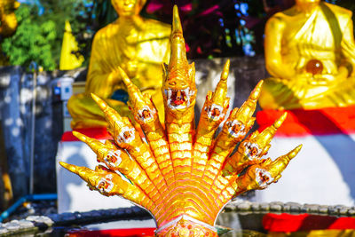 Close-up of buddha statue against building