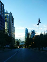 Trees in city against clear sky