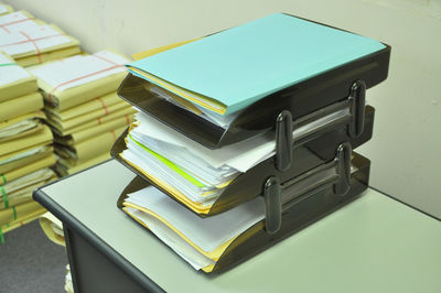 Close-up of stacked yellow papers on table