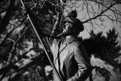 Low angle view of statue against trees