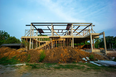 Low angle view of abandoned metallic structure against sky