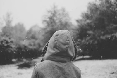 Close-up of person in snow against sky
