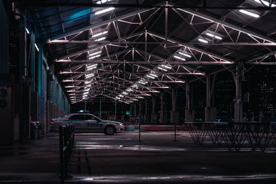 Cars parked on illuminated road at night