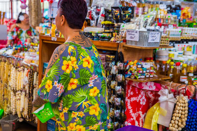 Rear view of woman standing at market stall