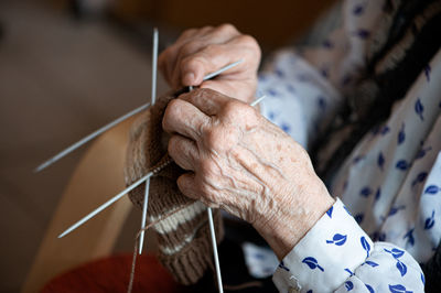 Midsection of woman crocheting
