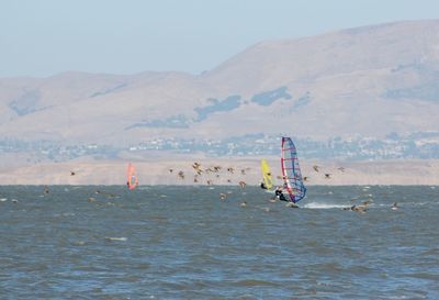 Scenic view of sea with mountains in background