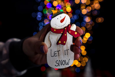 Midsection of man holding christmas decoration