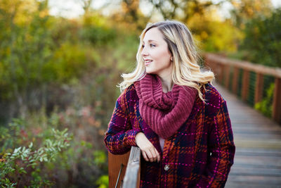 Young woman standing on footbridge