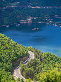 High angle view of road by river amidst trees