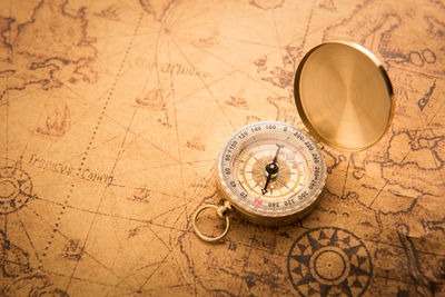Close-up of navigational compass on map