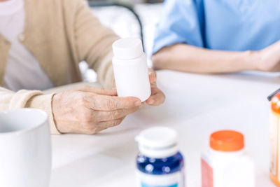 Midsection of doctor examining patient in laboratory