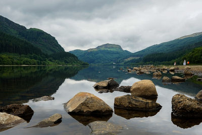 Scenic view of lake and mountains against sky