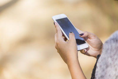 Midsection of woman using mobile phone