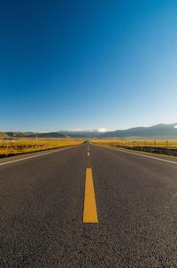 Empty road along landscape