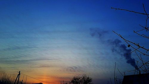 Low angle view of silhouette trees against sky at sunset