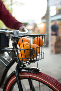 Close-up of fresh oranges in basket on bicycle