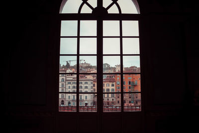 A view of florence buildings from a dark museum room through a window