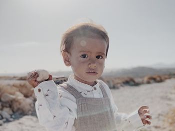 Portrait of a kid looking into camera in the desert