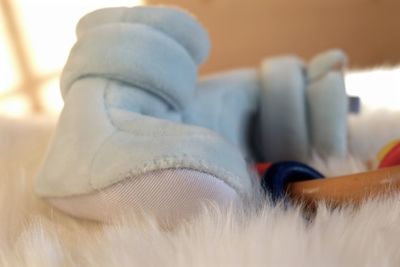Close-up of baby booties on fur