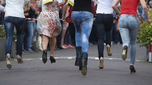 Low section of women running on road