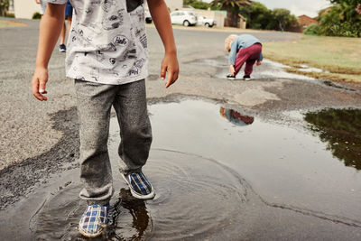 Low section of woman walking on road