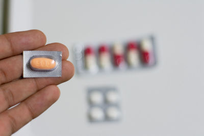 Close-up of hand holding eyeglasses against blurred background