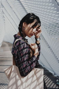 Portrait of a young woman sitting outdoors