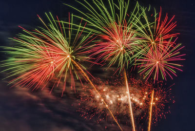 Low angle view of firework display at night