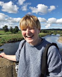 Portrait of smiling boy against sky