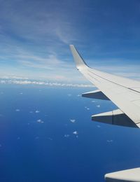 Airplane flying over blue sky