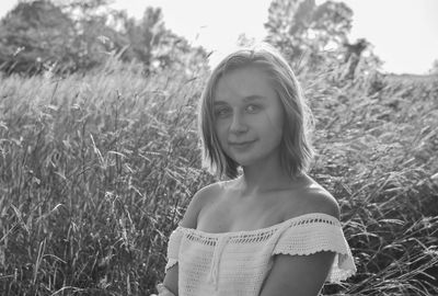 Portrait of smiling young woman on field