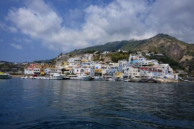 Townscape by sea against sky in town