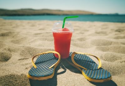 Close-up of drink on table at beach