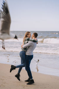 Full length of woman on beach against sky