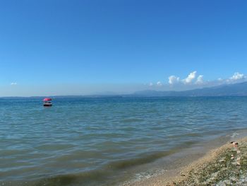 Scenic view of sea against blue sky